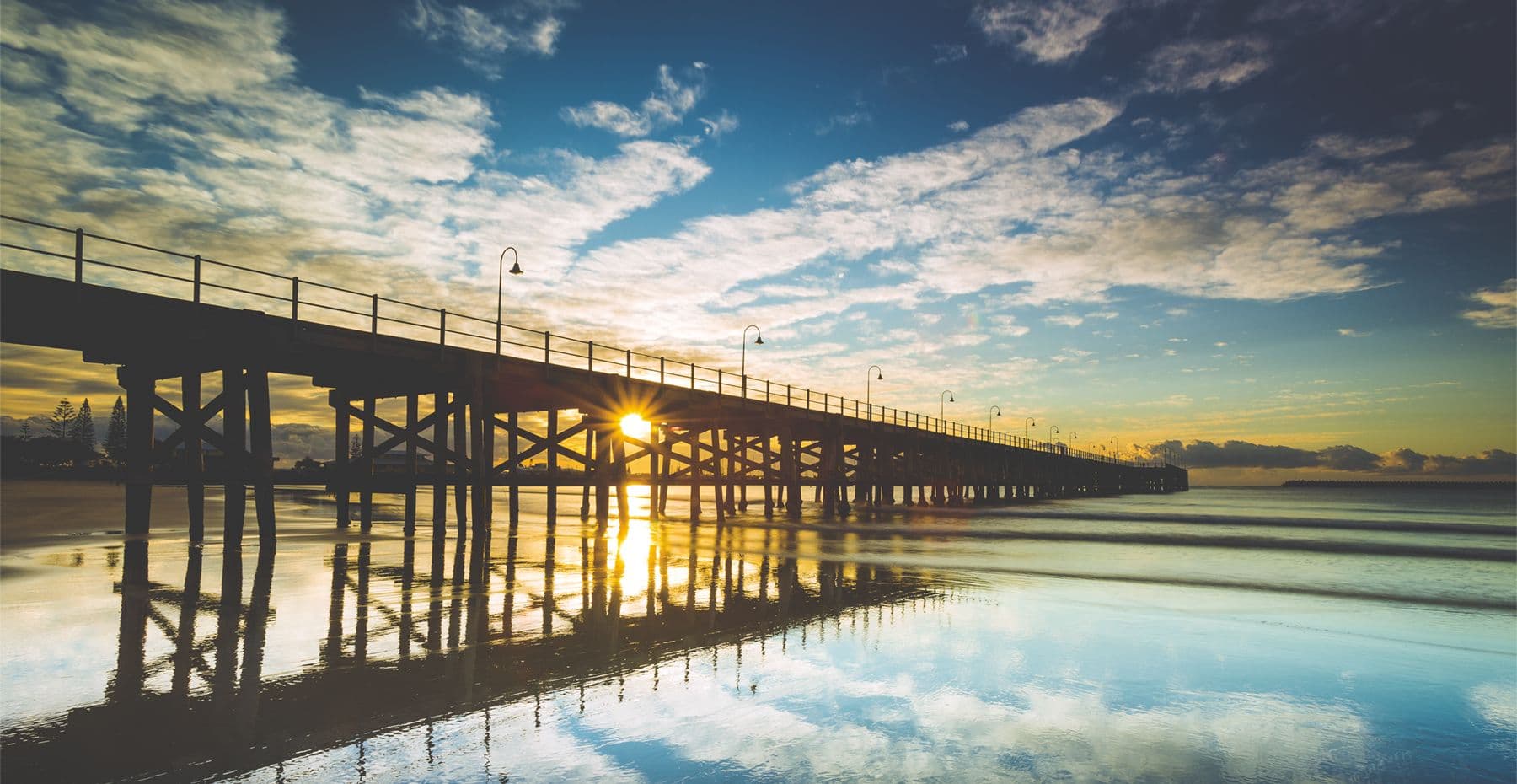 Early SCL — the team when it was small, or the Coffs Coast setting. Something that reads as a beginning rather than a polished business.